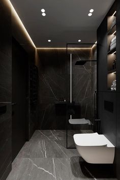 a modern bathroom with black and white marble flooring, dark walls, and lighting