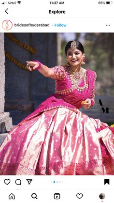 a woman in a pink and gold dress posing for the camera with her arms outstretched