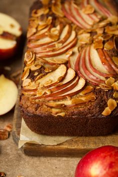 an apple and walnut cake on a cutting board