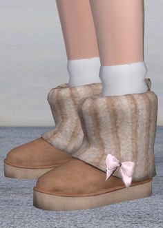 a pair of brown boots with white socks and a pink bow