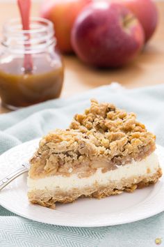 a slice of apple crisp cheesecake on a white plate