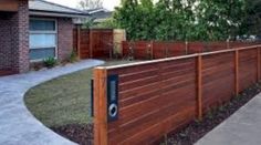 a wooden fence in front of a house