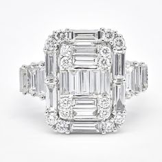 an emerald cut diamond ring with three baguetts in the center and side stones