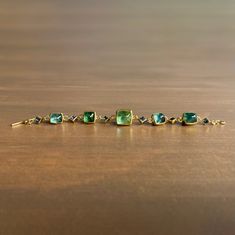 Cool, ethereal tones flow through a rhythmic mix of shapes and sizes in this stunning aquamarine & tourmaline bracelet.

22k, 18k yellow gold 
Tourmaline 8mm x 8mm (5/16" x 5/16"), 11mm x 10mm (7/16" x 3/8")
Aquamarine 4mm x 4mm (3/16" x 3/16")
Bracelet is 7" long Aquamarine Bracelet, Tourmaline Bracelet, Gemstone Bracelet