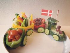 a plate topped with cucumbers, tomatoes, and other veggies next to a flag