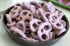 a pan filled with purple pretzels sitting on top of a table