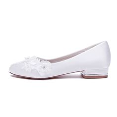 a pair of white shoes with flowers on the toe and heel, all in satin material