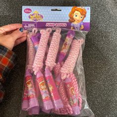 a package of pink toothbrushes with princess characters on the front and back of them