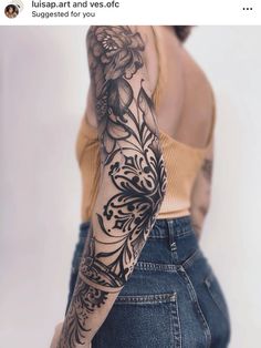 a woman's arm with flowers and leaves tattooed on her left arm, in front of a white background