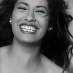 a black and white photo of a woman smiling