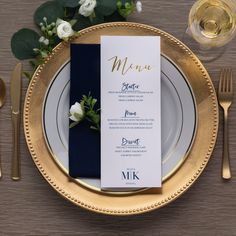 a table setting with place cards, silverware and napkins on top of it