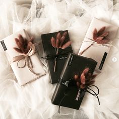 three small packages with feathers tied to them