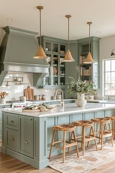 a kitchen with green cabinets and wooden stools