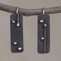 A unique design from Leslie Granthon of Peru this pair of drop earrings makes a bold accessory. Each rectangular earring is crafted from sterling silver and given a dark oxidized finish. Cheap Handmade Metal Earrings, Cheap Symbolic Metal Earrings, Luxury Modern Hand Forged Earrings, Cheap Rustic Nickel-free Earrings, Drop Earrings Silver Handmade Jewelry, Luxury Artisan Sterling Silver Earrings, Cheap Artistic Metal Earrings, Luxury White Bronze Jewelry With Oxidized Finish, Cheap Oxidized Metal Earrings