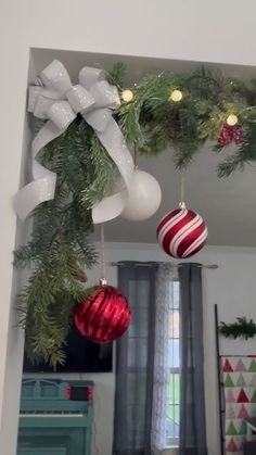 christmas decorations hanging from the ceiling in a room with white and red ornaments on it