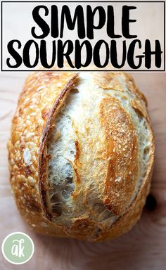 a loaf of sourdough sitting on top of a wooden cutting board with the words simple sourdough above it