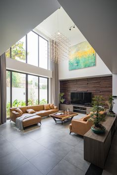 a living room filled with lots of furniture and a large painting on the wall above it