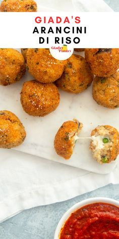 an appetizer is served with marinara sauce and fried meatballs in the background