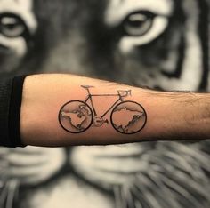 a man's arm with a black and white photo of a bike on it