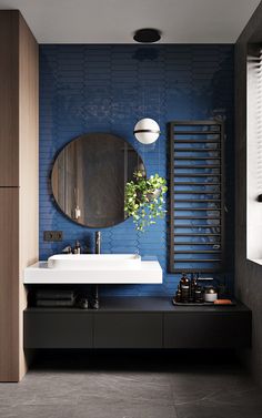 a modern bathroom with blue walls and flooring is pictured in this image, there is a mirror on the wall above the sink