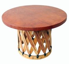 a round wooden table with metal base and wood slats on the top, against a white background