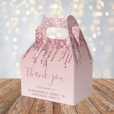 a pink thank you box on a wooden table