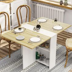 a kitchen table with two chairs and plates on it