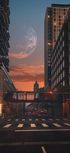 a city street at night with tall buildings and a clock tower in the distance under a cloudy sky