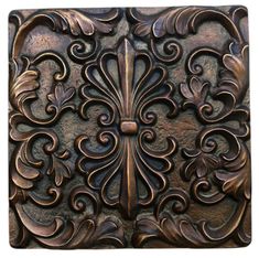 an intricately carved metal panel with flowers and leaves