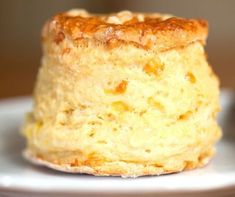 a close up of a pastry on a plate with other food items in the background