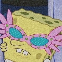 the spongebob is wearing pink sunglasses and holding something in his hand as if he's going to eat some food