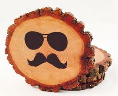 a piece of wood with a mustache and sunglasses on it