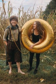 two people standing next to each other holding an inflatable tube