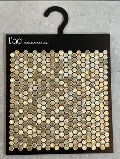 a black hanger with gold hexagonal tiles on it