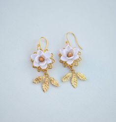 Featuring Statement earrings in white Magnolia with gold center with gold tone brass leaves. Note : if you prefer different color as seen in the last picture, please drop a note. Otherwise it will be shipped as white-gold as pictured. Details: Hand-Sculpted magnolia .Size approx : 18-19mm. Flowers glued gold plated over brass filigree as pictured. Brass Leaves in white gold tone. French hook Ear-wires. Made to order : 3-5 business days for single item plus shipping time. However if you need them Delicate Nickel-free White Earrings, Delicate White Nickel-free Earrings, White Brass Earrings For Gift, White Brass Earrings As Gift, White Flower-shaped Pierced Earrings, White Brass Pierced Earrings, White Brass Earrings For Pierced Ears, Handmade White Brass Earrings, White Brass Earrings With Ear Wire