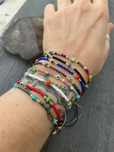 -------Price per Item------ Choose your favorite color and stay in style and safe at the same time with this multiple evil eye beaded bracelets. They are dainty and are easy to match any outfit and other accessories. Available in 7 different colors. They are size adjustable what makes them the perfect gift. A most have addition to your everyday bracelets collection. ⚡️GET 20% OFF NOW⚡️ JOIN AKASHI'S VIP LIST and Shop ⚡️Join Akashi's VIP list for early bird discount access⚡️ Paste into your browser http://eepurl.com/hgCMM1 and follow the simple steps. ⚡️To see more unique jewelry, click the link below👇 https://www.etsy.com/shop/AkashiJewelry?ref=seller-platform-mcnav ⚡️Get a cool outfit for your jewelry, check out Akashi Apparel⚡️ 👇 https://www.etsy.com/shop/AkashiApparel?ref=seller-platf Trendy Adjustable Multicolor Evil Eye Bracelet, Everyday Multicolor Resizable Bracelet, Adjustable Colorful Spiritual Bracelets, Resizable Multicolor Evil Eye Bracelet For Friendship, Trendy Adjustable Evil Eye Bracelet With Colorful Beads, Spiritual Multicolor Bracelet, Rainbow Evil Eye, Everyday Bracelets, Nazar Bracelet