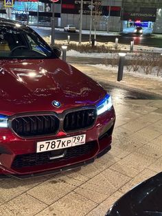 a red car is parked on the side of the road