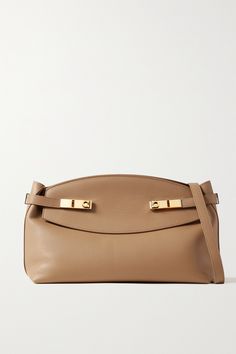 Ferragamo's shoulder bag is named for the subtle gathering along the sides that creates a 'hug' effect. Expertly made in Italy from beige leather, it's detailed with signature gold-tone 'Gancini' buckles and has a removable strap so you can carry it like a clutch. There's plenty of space inside for essentials like your phone, wallet and sunglasses case. Ferragamo Bag, Brown Accessories, Large Pouch, Soft Autumn, Essential Items, Large Shoulder Bags, Phone Wallet, Leather Pouch, Pouch Bag