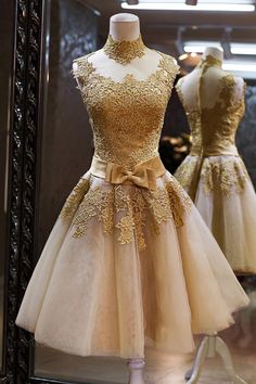 a dress on display in front of a mirror with mannequins behind it