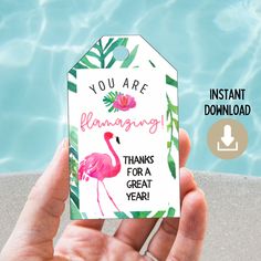 someone holding up a card that says, you are flamingo thanks for a great year