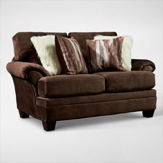 a brown couch with two pillows on it