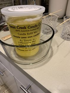 a glass bowl filled with liquid sitting on top of a counter