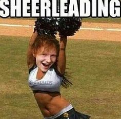 a cheerleader is smiling and holding her pom poms up in the air