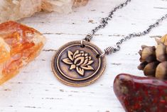 CANADIAN BUYERS: Canadian listing prices in my shop are GST/HST included.  Artisan Solid Bronze and Sterling Silver Lotus Necklace Necklace Length: 16-18" or 18-20" (mannequin is wearing 18" length) Extender Chain: 2" Pendant Size: 20mm Chain: 1.7mm Rolo Chain Clasp: Spring Ring Clasp Materials: Solid Bronze, Sterling Silver This artisan mixed metal necklace features a handcrafted solid bronze lotus pendant. The pendant was hand casted by me and fired in a kiln.  The necklace has been finished w Artistic Flower Pendant Necklaces For Gifts, Handmade Artistic Jewelry For Meditation, Bronze Flower-shaped Jewelry Gift, Symbolic Handmade Flower Pendant Jewelry, Handmade Vintage Necklace With Flower Shape, Bohemian Flower-shaped Nickel Free Necklace, Bohemian Flower-shaped Nickel-free Necklace, Handmade Vintage Flower Shape Necklaces, Artistic Stamped Jewelry As Gift