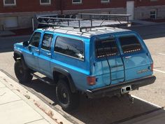 a blue pick up truck parked in a parking lot