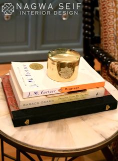 three books stacked on top of each other in front of a chair with the title nagwa self interior design