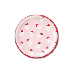 a pink and white plate with santa hats on it's side, in front of a white background