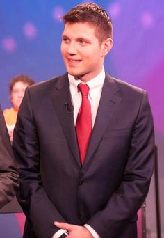 a man in a suit and red tie