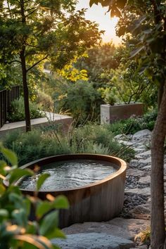 an outdoor hot tub surrounded by trees and plants