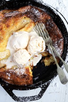 a skillet with some ice cream on top of it and a fork next to it